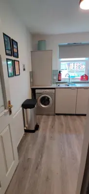 a kitchen with a sink and a washing machine at Anchors Rest in Ayr