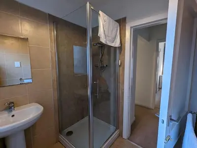 a bathroom with a shower and a sink at Two bedroom flat in Bridge of Allan, Stirling in Bridge of Allan
