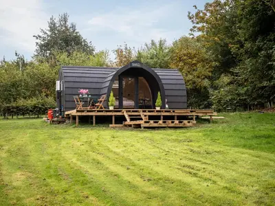 a black dome tent sitting in a field at Pentland Pod - Cottage in Penicuik