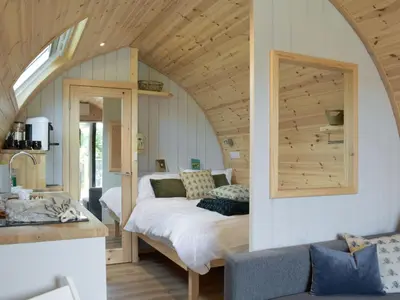 a bedroom with a bed in an attic at Pentland Pod - Cottage in Penicuik