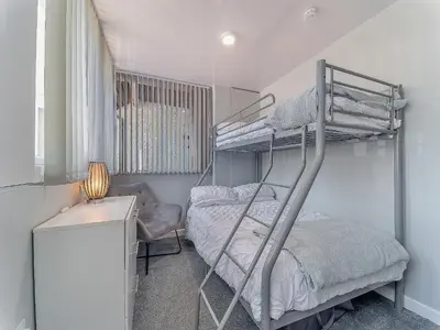 a bedroom with a bunk bed and a desk at 3 Ladyknowe Uk39969 in Moffat
