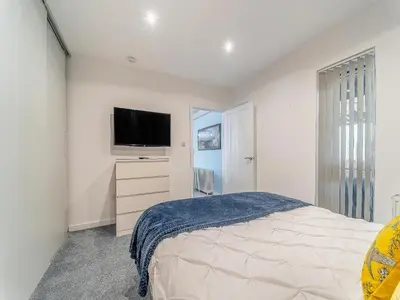 a bedroom with a bed and a flat screen tv at 3 Ladyknowe Uk39969 in Moffat