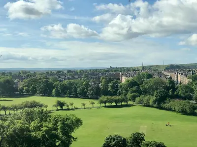 a large green field with a city in the background at Simpsons Loan - 428 in Edinburgh