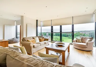 a living room with furniture and large windows at Simpsons Loan - 428 in Edinburgh