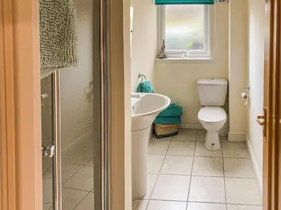 a bathroom with a toilet and a sink at Dalnafeidh Beag - Cottage in Portnacroish