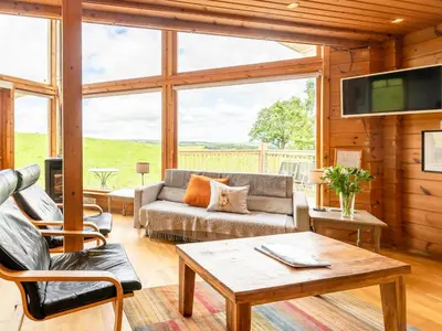a living room with a couch and a table at Tunturi - Cottage in Linlithgow