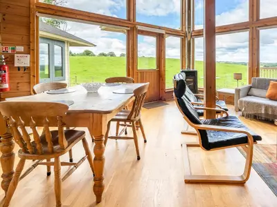 a dining room with a wooden table and chairs at Tunturi - Cottage in Linlithgow