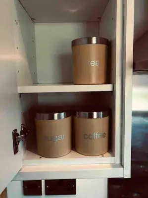 four brown pots in a cupboard with at Cosy Home with Free Parking Near Edinburgh St Andrews M90 & Amazon in Dunfermline