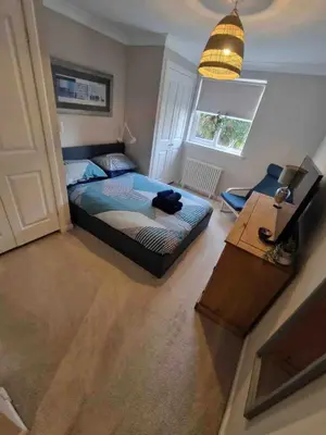 a bedroom with a bed and a table and a window at Cosy Roseburn Apartment, Edinburgh - 2 Bedrooms, FREE PARKING in Edinburgh