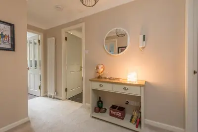 a room with a table and a mirror on the wall at Cosy Roseburn Apartment, Edinburgh - 2 Bedrooms, FREE PARKING in Edinburgh