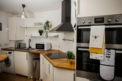 a kitchen with a sink and a stove top oven at Tower Square House in Alloa