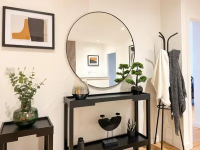 a mirror on a table in a room at Lovely 2 Bed Duplex Apartment with Hydro Views in Glasgow