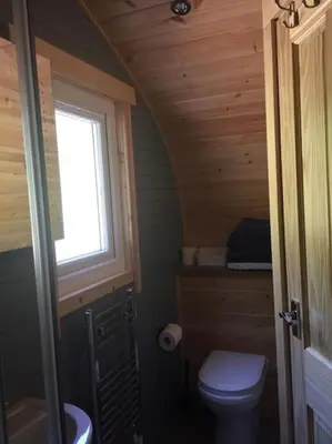 a small bathroom with a toilet and a window at The Boathouse pod in Onich