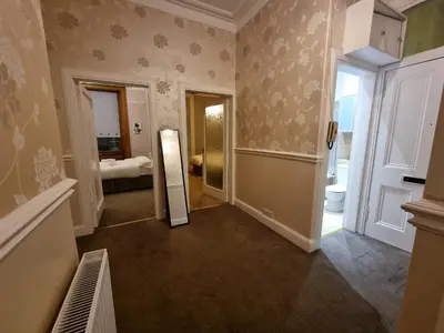 a room with a hallway with a mirror and a bathroom at Bright 3 Bedroom Edinburgh City Apt in Edinburgh