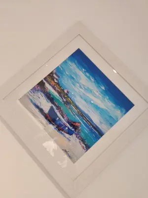 a picture of the ocean in a white frame at No 7 Westbay Apartment in Oban
