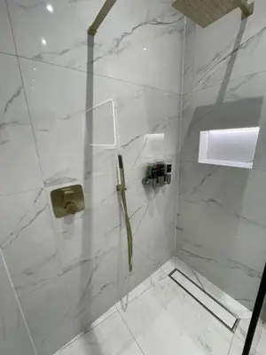 a bathroom with a shower with a glass door at Laurieston Inn in Falkirk