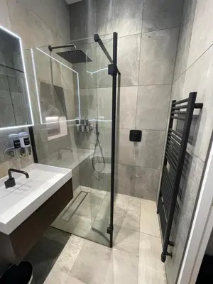 a bathroom with a shower and a sink at Laurieston Inn in Falkirk