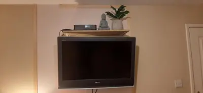 a flat screen tv sitting on a wall at Delightful home stay - Double ensuiteroom. in Glasgow