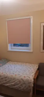 a bedroom with a bed and a window with a blind at Delightful home stay - Double ensuiteroom. in Glasgow