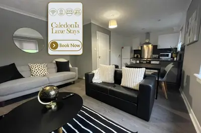 a living room with a couch and a table at Dunbeth House in Coatbridge