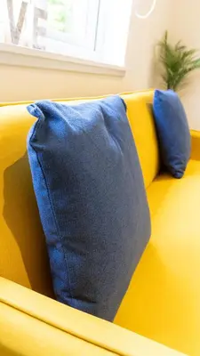 a blue blanket on the back of a yellow couch at The Riverside in Alloa