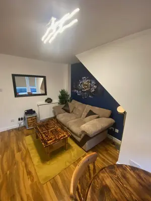 a living room with a couch and a table at cosy 1 bed flat Largs in Largs