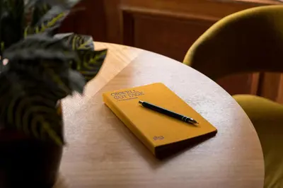 a pen sitting on top of a notebook on a table at JOIVY Contemporary Cottage with Free Parking in Edinburgh