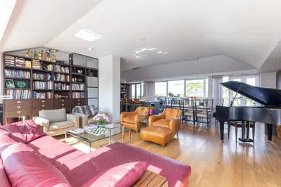 a living room with a couch and a piano at JOIVY Beautiful Penthouse with Terrace & Jacuzzi in Edinburgh