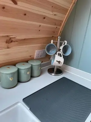 a kitchen counter with pots and pans and a sink at Glamping Pods in Milngavie
