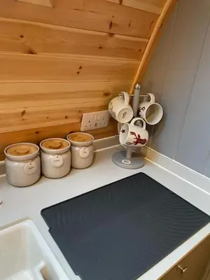 a kitchen counter with a sink and several pots and pans at Glamping Pods in Milngavie