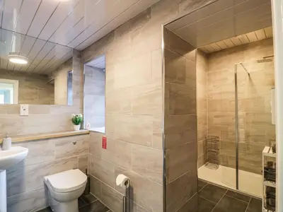 a bathroom with a shower and a toilet and a sink at Rothiemay in Girvan