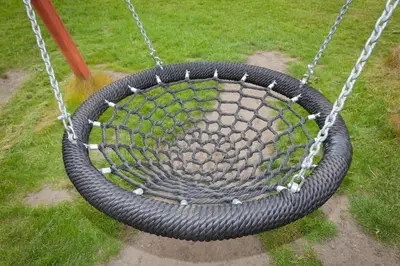 a black tire swing with a chain at Laurel Cottage at Williamscraig Holiday Cottages in Linlithgow