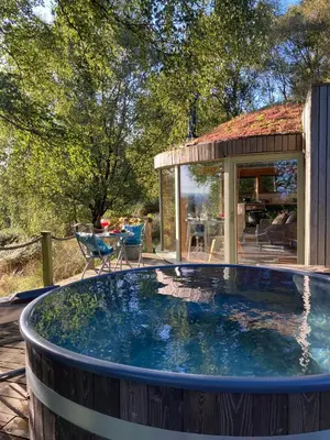 a large plunge pool in a backyard with a house at Craigmaddie Muir Roundhouse with Hot Tub Romantic, Luxury, Rural Stay for 2 Near Milngavie in Glasgow