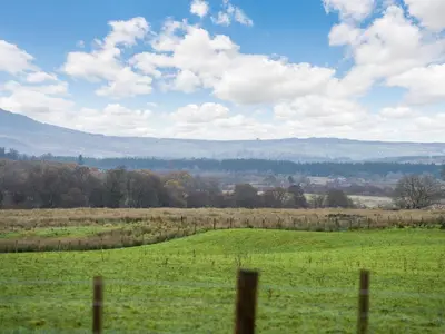 a field of green grass with a fence at Fiadh Ruadh-Uk40008 in Gartmore