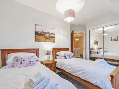 a bedroom with two beds and a mirror at Gartclach-Uk40001 in Gartmore