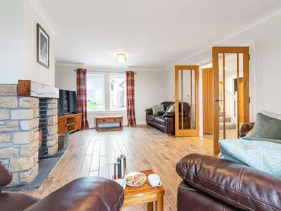 a living room with a couch and a fireplace at Gartclach-Uk40001 in Gartmore