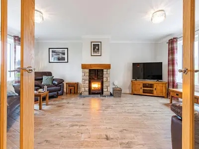 a living room with a fireplace and a tv at Gartclach-Uk40001 in Gartmore