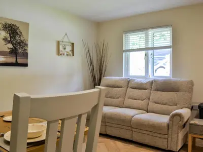 a living room with a couch and a table at Holly - Apartment in Aberfoyle