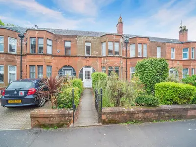 a brick building with a car parked in front of it at Charles House in Largs