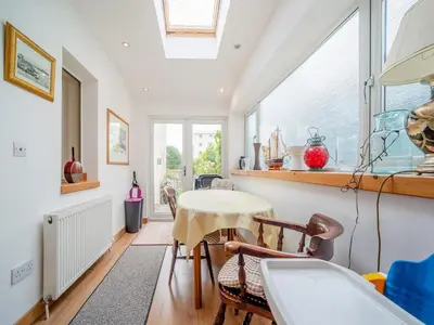 a room with a table and chairs and a window at Charles House in Largs