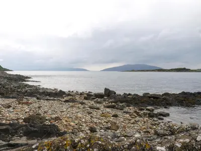 a rocky shoreline with a large body of water at Siskin Lodge - Uk39664 in Lunga