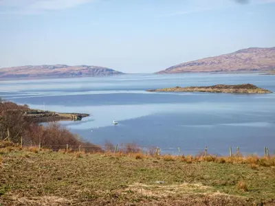 a large body of water with a small island in it at Siskin Lodge - Uk39664 in Lunga