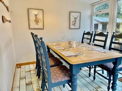 a dining room table with chairs and a blue table sidx sidx sidx at Traditional Cottage in West Kilbride Village in Seamill
