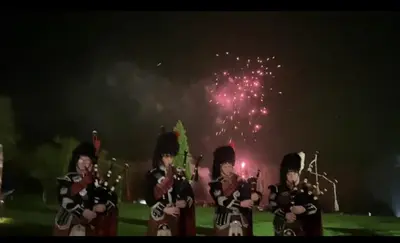 a group of people in military uniforms with fireworks at Fabulous Lodges at Cameron House, Loch Lomond in Balloch
