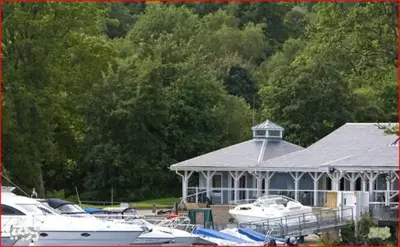 a group of boats parked in front of a building at Fabulous Lodges at Cameron House, Loch Lomond in Balloch