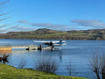 a plane sitting on a dock in the water at Fabulous Lodges at Cameron House, Loch Lomond in Balloch