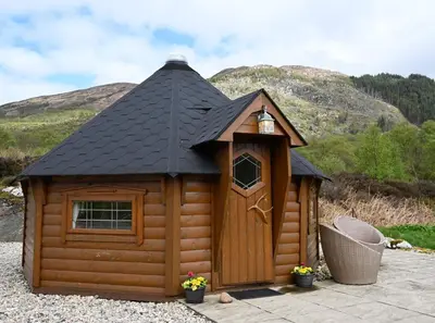 a small wooden cabin with a black roof at Leven View Lodges - Callart in Fort William
