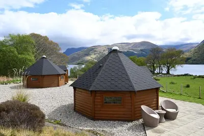 two small wooden buildings sitting on top of gravel at Leven View Lodges - Carness in Fort William