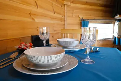 a table with a blue table cloth and glasses on it at Leven View Lodges - Carness in Fort William