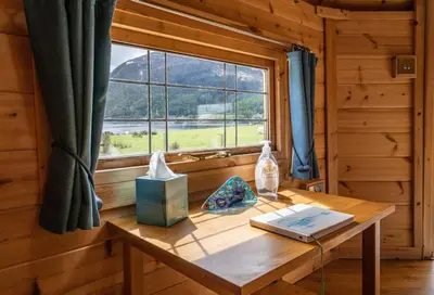 a wooden table in a room with a window at Leven View Lodges - Carness in Fort William